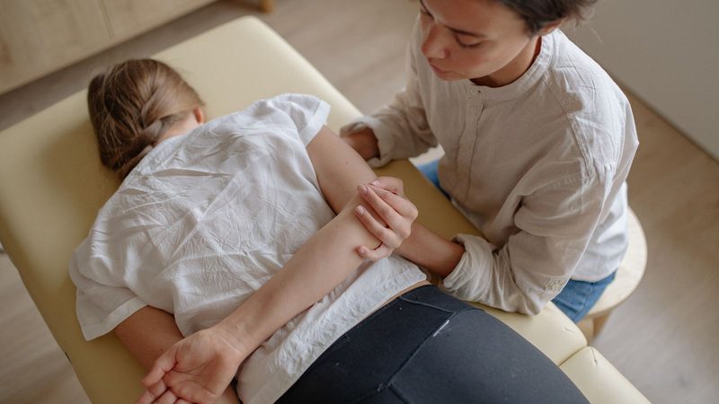A chiropractor performing a hands-on spinal adjustment